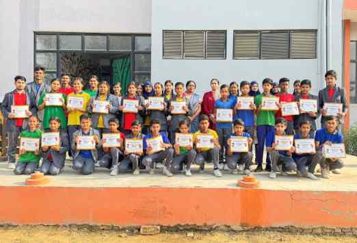 Students holding certificates after an academic achievement ceremony