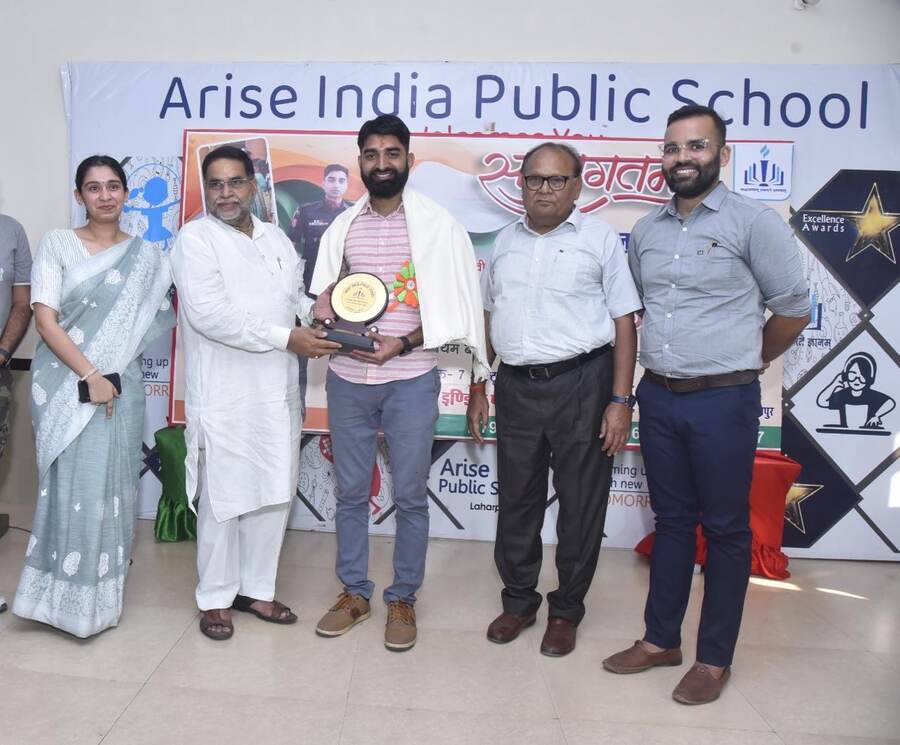 Arise India Public School representatives receiving an Excellence Award on stage