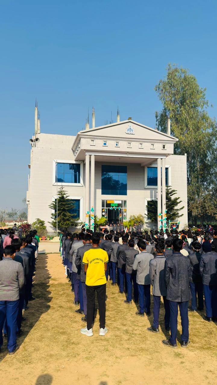 Students standing in formation facing the main school building during an assembly