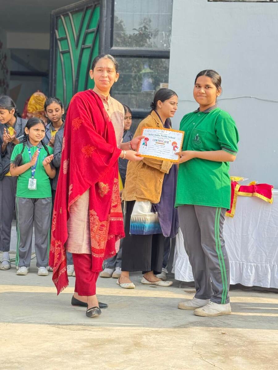 A teacher presenting a certificate to a student in front of classmates