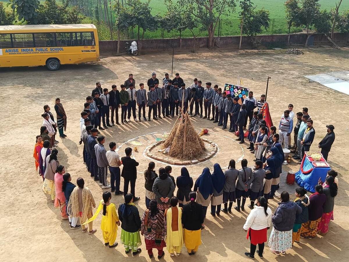 Students and staff gathered around a bonfire for a Lohri celebration