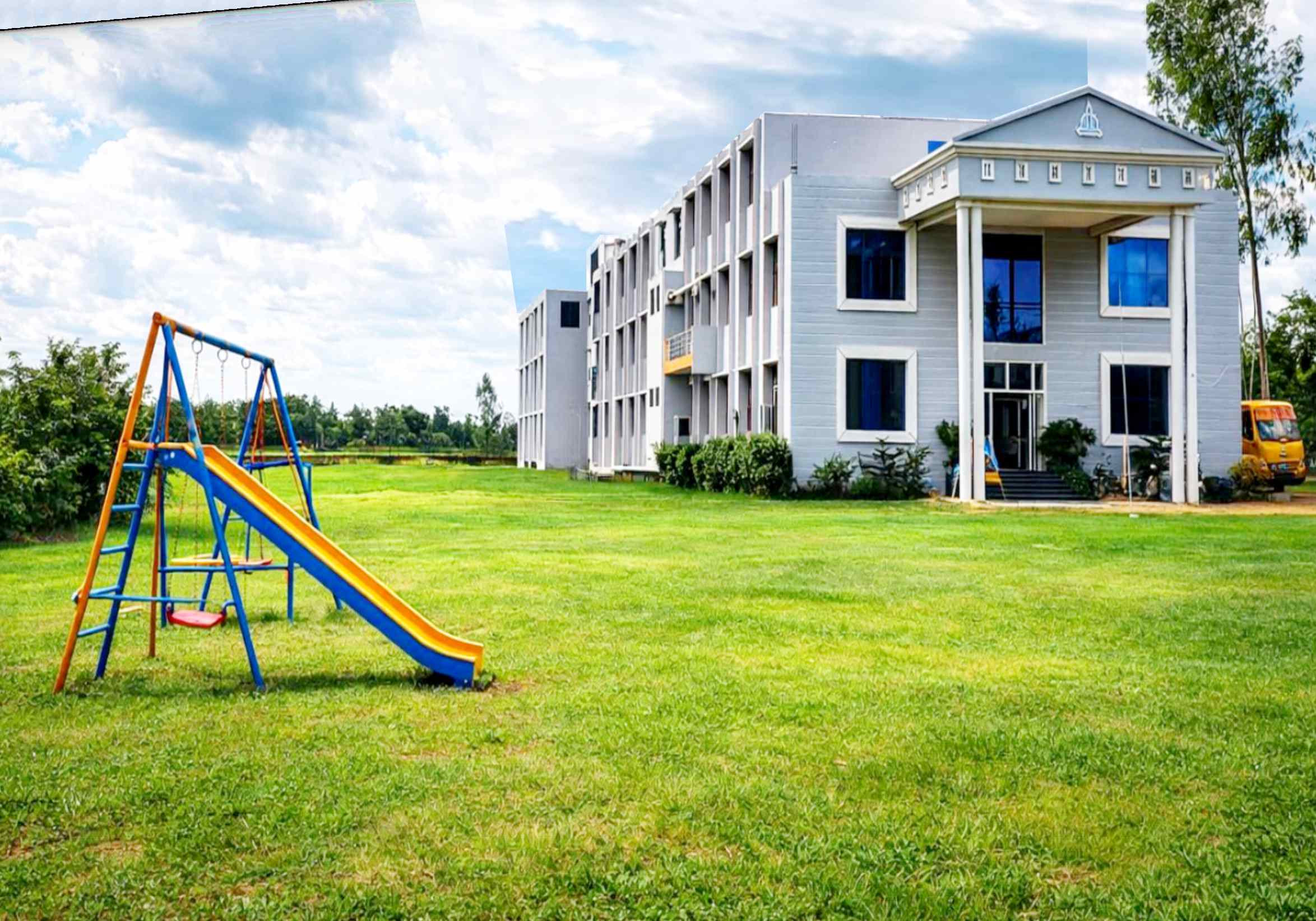 Arise India Public School campus building with a green playground and children's play slide