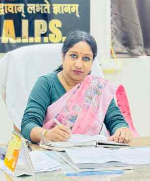 Portrait of Mrs. Kamal Sharma, Principal of Arise India Public School, at her desk